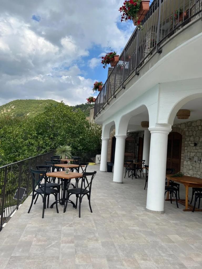 BBB terrace loggia with mountain views and dining tables