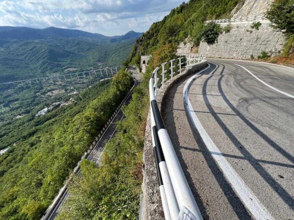 Clifftop mountain road with valley and viaduct below
