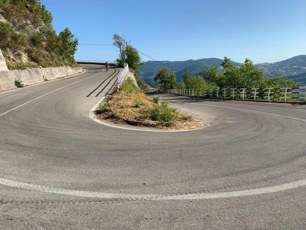 Lone cyclist on a hairpin bend in the Abruzzo mountains